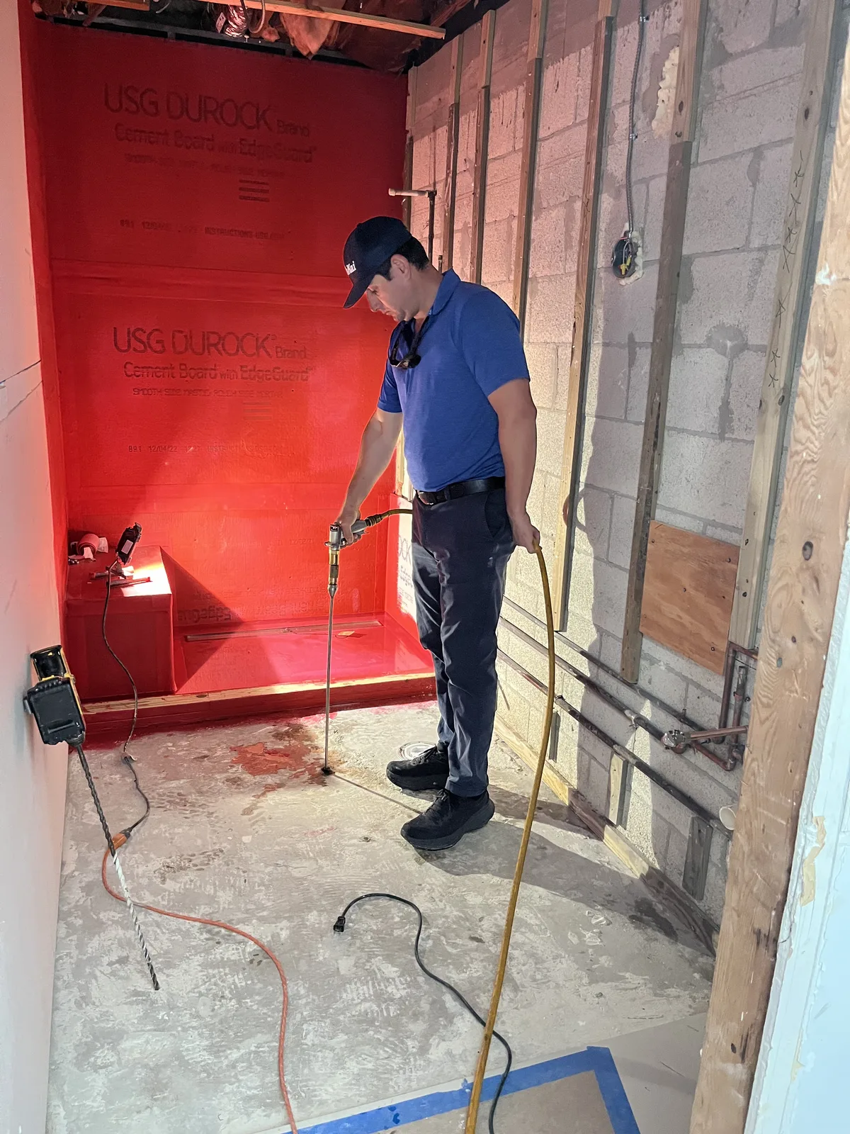 Prime Enviro technician applying a preventative termite treatment inside a home under construction
